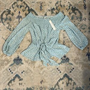 She + Sky over the shoulder top. Pale green color.